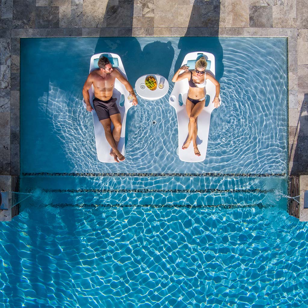 http://www.aquablumosaics.com/cdn/shop/files/ShayzIn-PoolLoungerWithOptionalRisers_LuxuryPoolLoungeChairInstallation.jpg?v=1701191871